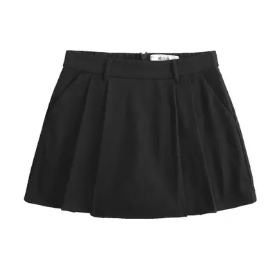 model wearing black midi dress with buttons going down