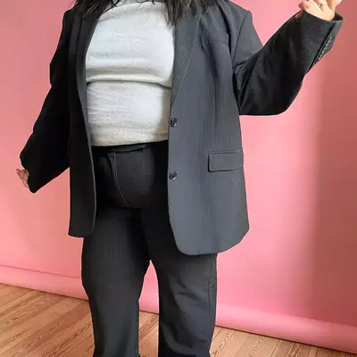 Model with gray corduroy blazer and pants and light gray heather t-shirt