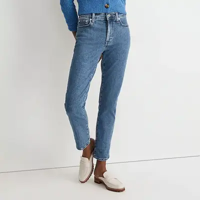 model wearing blue jeans with cream loafers, zoomed in