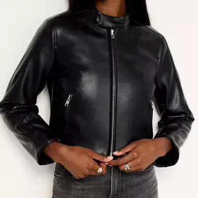 Model wearing a black faux leather moto jacket 