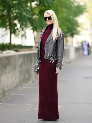 Model is wearing a black velvet one-shoulder mini dress 