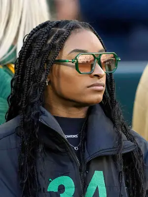 Simone Biles wearing green sunglasses