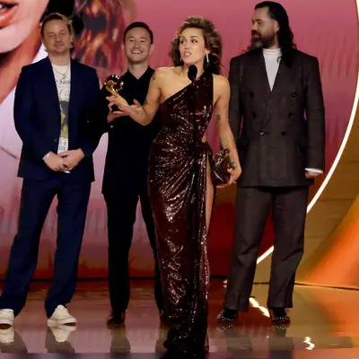 Miley Cyrus at Grammy Awards in burgundy dress