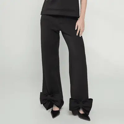Saga NYC Black Bow Wide-Leg Pants with bows at ankles and black pointed-toe shoes
