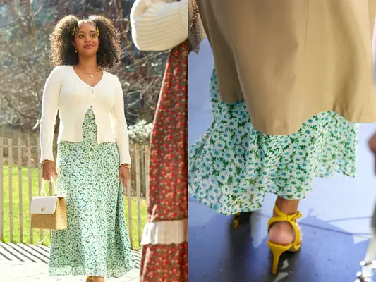 A woman wearing a green transitional sun dress in the park