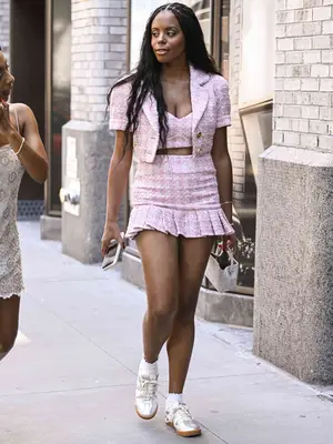 A guest is seen wearing a tweed Patbo jacket, top and skirt outside