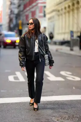 Woman wearing a black leather bomber jacket at NYFW