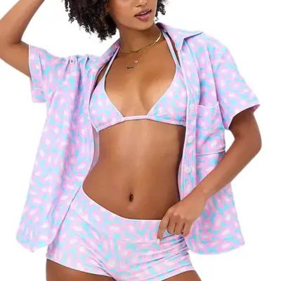 Frankies Bikinis Coco Terry Button Up Shirt in pink and blue floral on model styled with matching shorts and bikini top