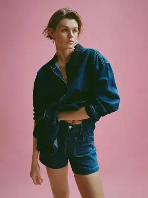 Person wearing denim shirt and shorts