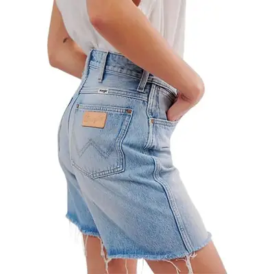 Wrangler Mid-Thigh Cowboy Shorts in light wash denim on model