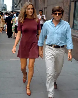 Sharon Tate wearing a burgundy mini dress with brown mary jane flats
