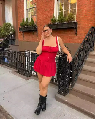 An influencer wearing a dress and boots. 