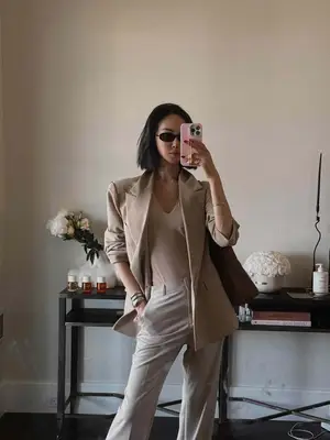 Chriselle Lim wearing monochromatic neutral outfit of blazer, shirt, pants, and bag