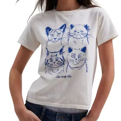 Model wearing a white t shirt with cats on it