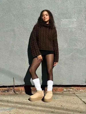 Toni Gentry wearing a brown sweater, shorts, tights, and Ugg booties