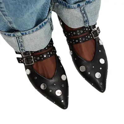 Person wearing Mary Janes with silver details