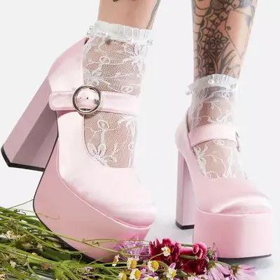 Cotton On Wren Pleated Mini Skirt in brown on model styled with cream cardigan and gray tank top