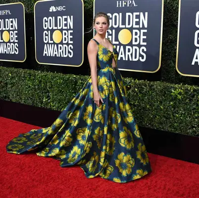 Taylor Swift wearing a navy gown with yellow flowers at the 77th Annual Golden Globe Awards