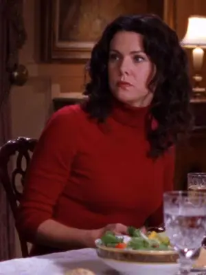 Lorelai Gilmore wears a red turtleneck sweater and red lipstick
