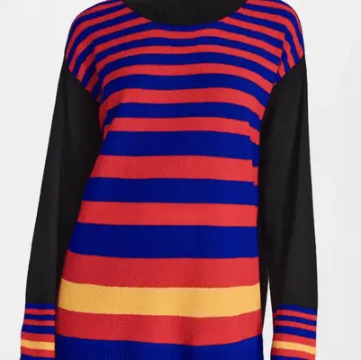 Rory Gilmore wears a gray and purple patterned v-neck sweater and black headband