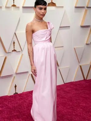 Zoe Kravitz wears a pastel pink Saint Laurent dress with bow detail to the 2022 Oscars