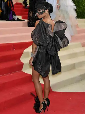 Zoe Kravitz wears a black Valentino minidress with bow back and masquerade mask to the 2016 Met Gala