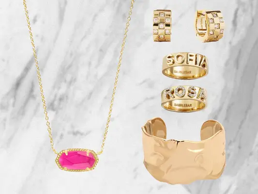 gold jewelry on a grey neutral background