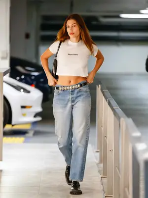 Hailey Bieber wears a white Nepo Baby t-shirt and light wash jeans while out in LA