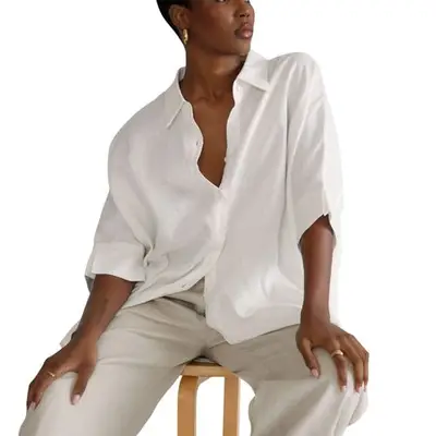 person wearing a white button-down shirt and slacks