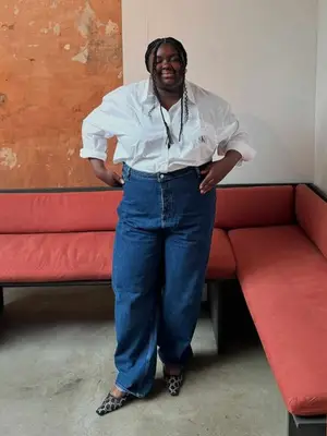 Abisola Omole wearing a button-down shirt and dark wash jeans