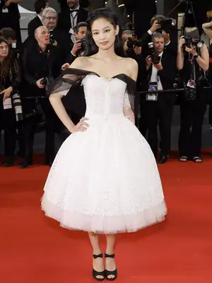 Jennie wears a Chanel Spring 2020 couture white lace dress to the 2023 Cannes Film Festival