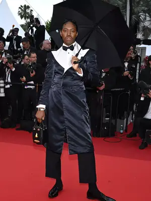 Jeremy O. Harris wears a Willy Chavarria suit and Schiaparelli bag at the 2023 Cannes Film Festival