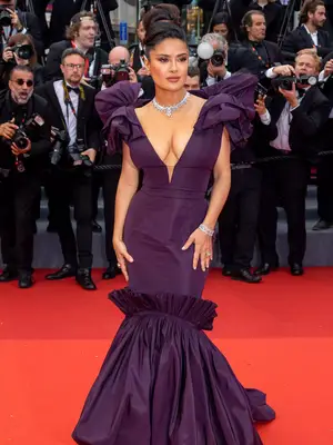 Salma Hayek wears a plum Alexander McQueen gown with voluminous shoulders to the 2023 Cannes Film Festival
