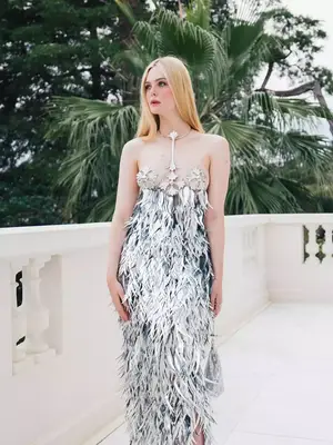 Elle Fanning wears a silver feathered Paco Rabanne dress with floral breastplates at Cannes 2023