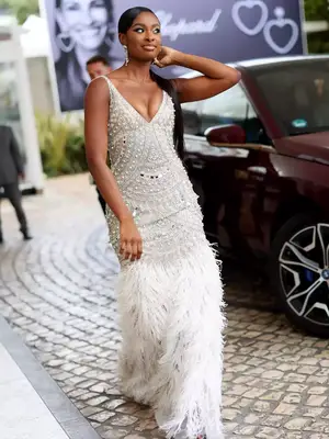 Coco Jones wears a white Naeem Khan gown with studs and feathers at the 2023 Cannes Film Festival