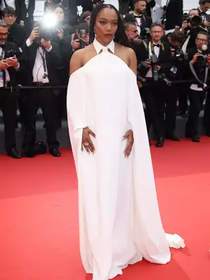 Naomi Ackie wears a collared, off-the-shoulder white Valentino gown to the 2023 Cannes Film Festival