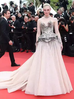 Elle Fanning wears a sparkly strapless Alexander McQueen gown and Cartier jewelry to the 2023 Cannes Film Festival