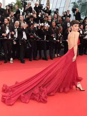 Simona Tabasco wears a backless red lace Lanvin gown to the 2023 Cannes Film Festival