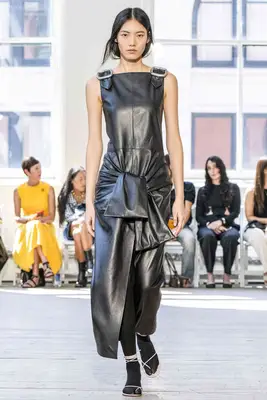 Model wears leather dress with tied waist and buckle straps at the Proenza Schouler Spring 2025 show
