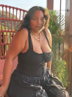 A model is wearing brown and white stripe chochet pants 