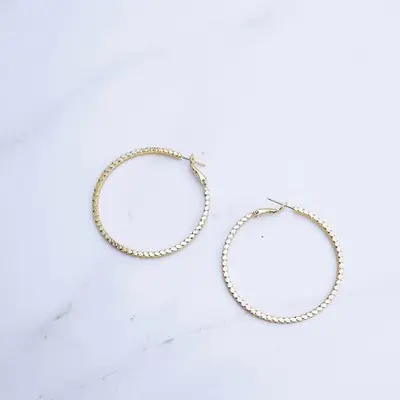 Silver hoops on a marble top table 