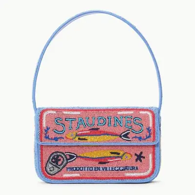 A close up of a blue and pink beaded purse with fish on it with 