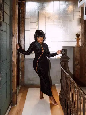 Micaela Verrelien wears a black velvet dress with several cutouts