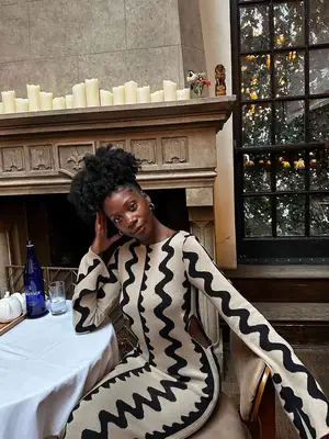 MYM Beauty editor Jasmine Phillips wears a black and white patterned dress with cutouts