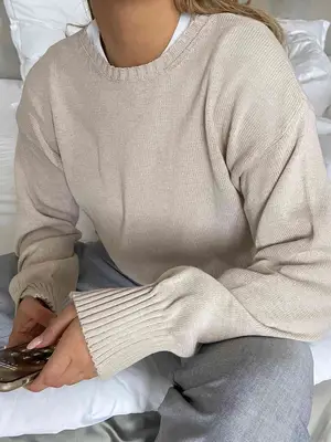 Close-up of Matilda Djerf wearing a beige sweater and heather linen pants