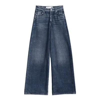 Lauren Chan wears a chambray shirt and light wash jeans