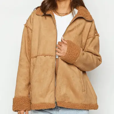 model wearing denim barn jacket with shearling collar