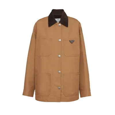 model wearing dark brown barn jacket with leather sleeves