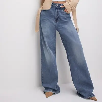 model wearing blue relaxed fit jeans