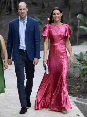 Kate Middleton wearing a pink metallic gown with a white clutch